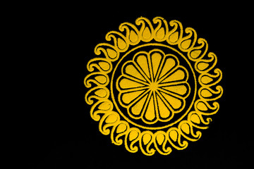 top view of yellow rangoli design on balck background with copy space. dhanteras decoration concept