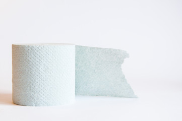 A roll of toilet paper lies on the table. On white background
