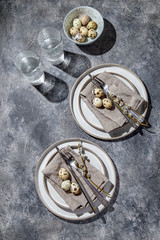 Easter festive table setting with quail eggs. top view