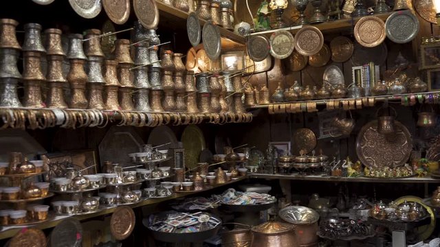 Street bazaar in Sarajevo full with delight cups, pots, tea kettles and souvenirs made of copper. Traditional antique shop made by Coppersmith