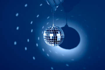 Mirror or disco ball, reflecting colorful lights on classic blue background. Party banner.