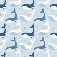 Seamless pattern with blue whales and golden starfish.