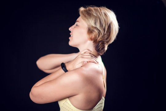 Woman feeling strong neck pain. Fitness and healthcare concept