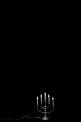 Vintage lamp on a black background isolated. Electric fixture in the form of candles.