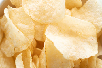 Potato chips scattered on table .