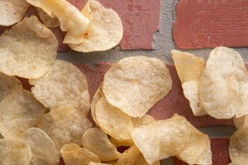 Potato chips scattered on table .