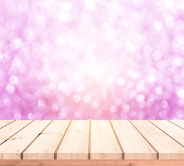 Wood table or wood floor with abstract pink bokeh background for product display