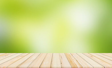 Naklejka na ściany i meble wood desk or wood floor with abstract green blurred background for products display