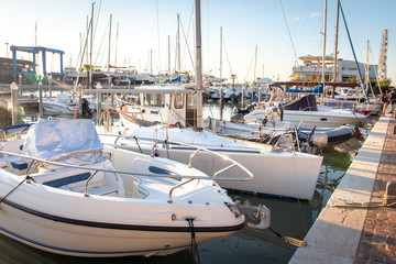 Fototapeta premium Mooring of sail boats in sea harbor. Sailboats stand in pier