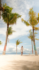 young woman on the beach with palmtrees
