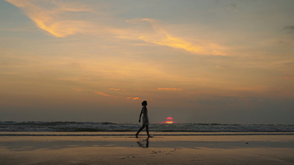 silhouette of a woman on the beach at sunset