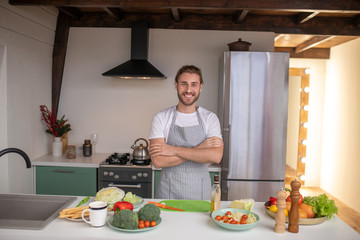 Smiling cook being ready to prepare a new dish