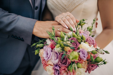 Background with flowers and hands with rings.