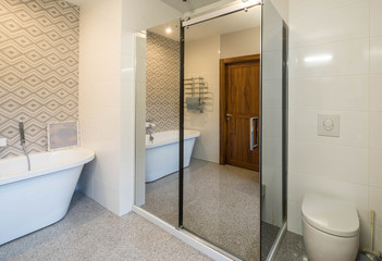 Fototapeta na wymiar Modern light interior of bathroom. Wooden door. White bath. Big window. Toilet.