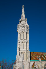 View of bell tower of Matthias church against the blue sky in Budapest