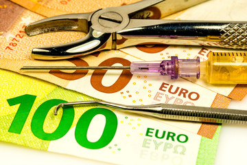 dental forceps and injection with euro bills