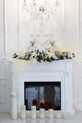 Natural Gas Fireplace decorated with Christmas ornaments, candles and basket of dried pine cones for the holiday season - Image