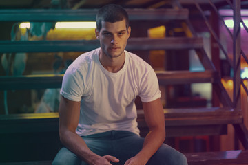 Close-up portrait of attractive male model. Young handsome man in a bar