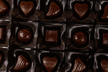 Assorted chocolate candies in a box. Close-up