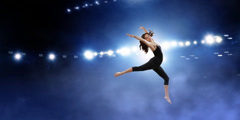Fototapeta na wymiar Gymnast girl in jump Mixed media