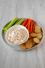 Homemade Pimento Cheese Dip with carrots, celery and crackers, side view.