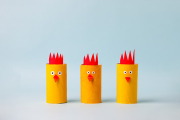 Set of Paper yellow chicken for Happy Easter seasonal party. Easy craft for kids on blue...