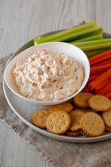 Homemade Pimento Cheese Dip with carrots, celery and crackers, low angle view. Close-up.