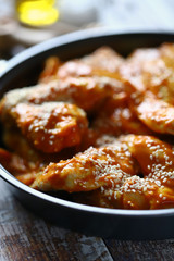 Raw chicken wings marinated in sesame sauce.