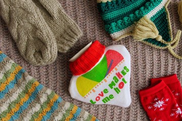 Heart-shaped warmer, knitted hat, scarf and mittens