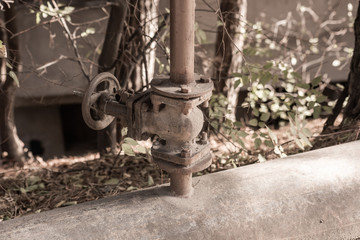 Old worn valve on pipes