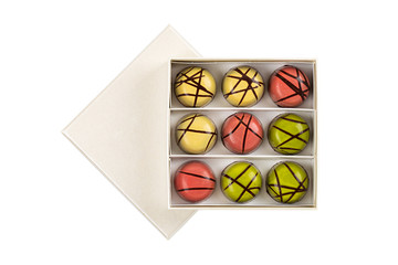 Assortment of luxury chocolate bonbons in box isolated on white background