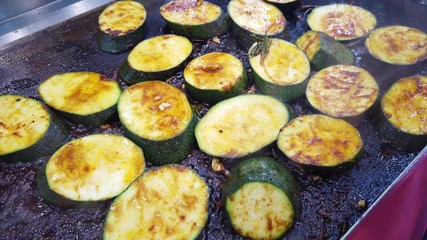 Roasting round slices of zucchini, vegetarian cuisine.