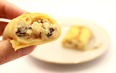 Pancakes with cottage cheese and raisins on a white background