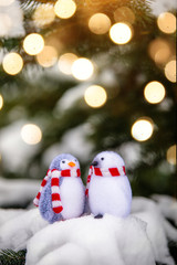 Two decorative penguins sit on the snow