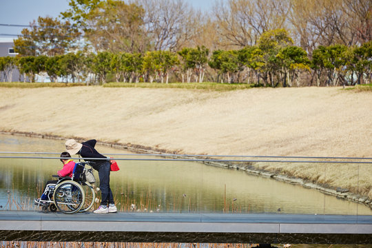 Man Pushing A Wheelchair