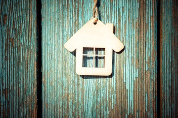 Obraz na płótnie Canvas The symbol of the house on a blue wooden background