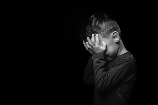 child whose depression is on a black background