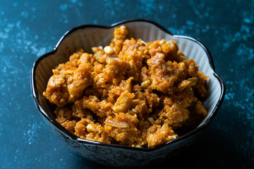 Gajar ka halwa / Halva is a carrot-based sweet dessert pudding from India. Garnished with Cashew/almond nuts and Served in a bowl.