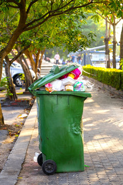Green waste bins in the park with garbage-tight waste and defective conditions