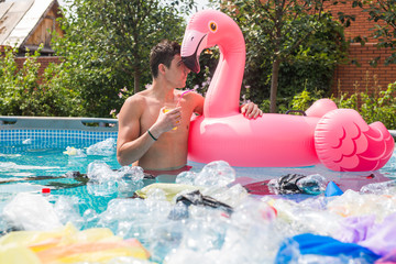 Ecology, plastic trash, environmental emergency and water pollution - shocked man standing in a...