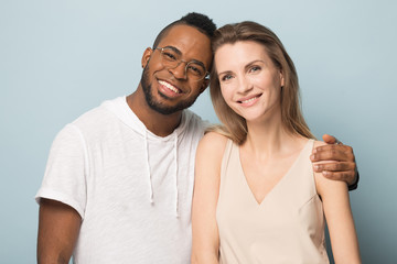 Naklejka premium Portrait of multiracial couple hug looking at camera