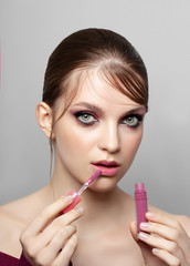 Facial Makeup. Closeup Of Beautiful Young Female Model  with lip gloss