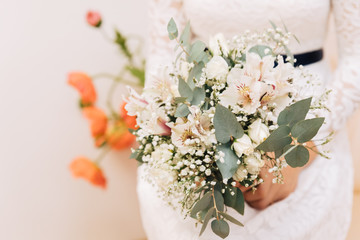 The bride's bouquet. The bride holds a bouquet of different flowers.