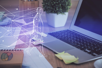 Desktop computer background in office and start up theme hologram drawing. Double exposure. Startup concept.