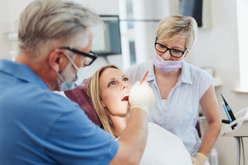 Fototapeta premium Dentist examining the teeth of a female patient