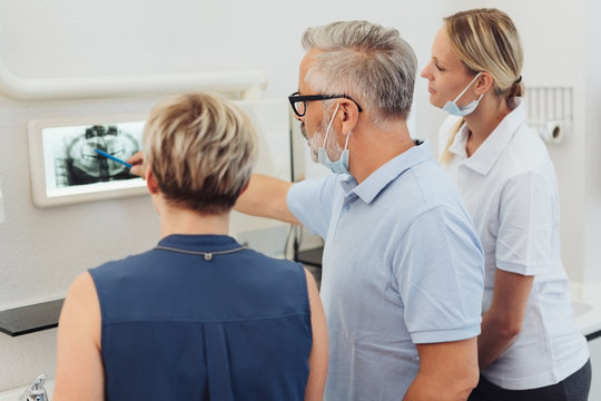Dentists explaining an x-ray to a female patient