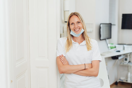 Relaxed happy dental nurse smiling at the camera