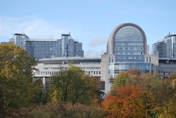 This photo shows beautiful autumn trees and the building of the European Parliament