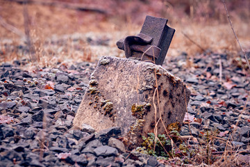 Iron remains of a former railway track in the track bed in a forest in Germany in wintertime.