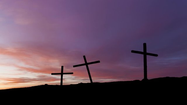 Timelapse of sunset with three crosses in silhouette on a hill. Crucifix concept